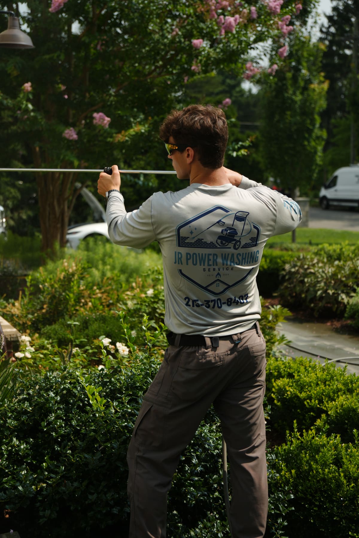 Jack Rishel of JR Power Washing working in a branded shirt
